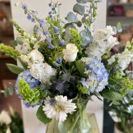 Blue and white mixed bouquet in a glass vase