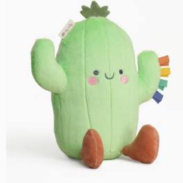 Plush green cactus toy with a smiling face and brown feet