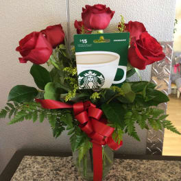 Red roses in a glass vase with a Starbucks gift card and red ribbon