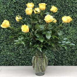 Yellow roses arranged in a clear glass vase