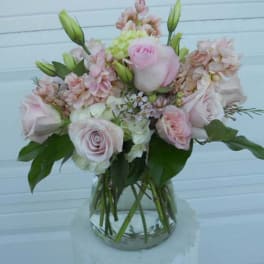 Pink and white flower bouquet in a clear glass vase