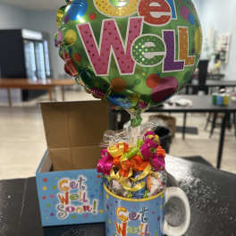 Get well balloon gift in a mug with candy and a card
