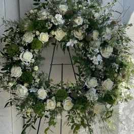 Large white rose wreath on a metal easel
