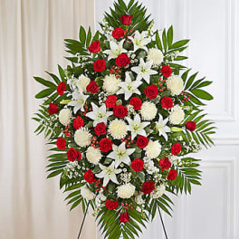 Standing floral spray with red and white flowers on an easel