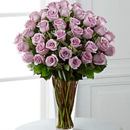 Bouquet of light pink roses in a clear glass vase