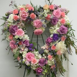 Heart-shaped floral wreath with pink and purple roses and white blooms