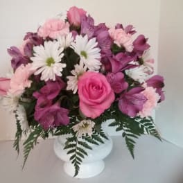Pink and white mixed flower arrangement in a white vase