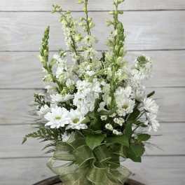 White floral bouquet with tall green spikes and a green ribbon wrap