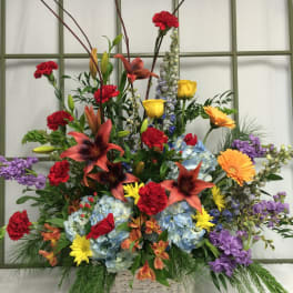 Colorful mixed flower arrangement in a woven basket