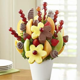 Fruit bouquet in a white vase with strawberries and chocolate-dipped fruit