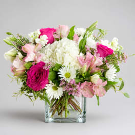 Pink and white mixed bouquet in a clear square vase