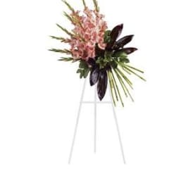 Pink floral spray on a white easel