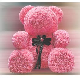 Pink rose teddy bear with a black ribbon bow