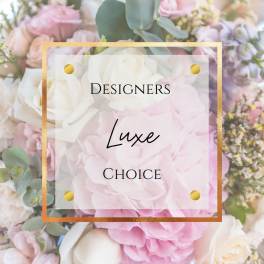 Pastel pink and white floral arrangement with gold-framed text overlay