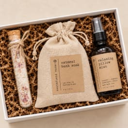 Gift box with bath soak, pillow mist, and a corked glass tube