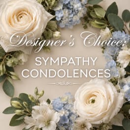 White roses and pale blue flowers arranged in a sympathy wreath with text overlay.