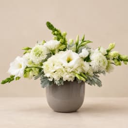White flowers arranged in a gray vase