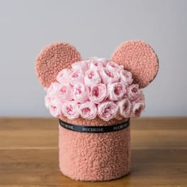 Pink rose bouquet arranged in a teddy bear-shaped box