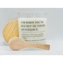 Coffee-scented candle in a glass jar with a wooden lid and spoon