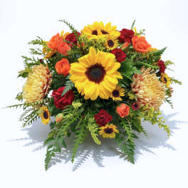 Mixed bouquet with sunflowers, orange roses, and red blooms