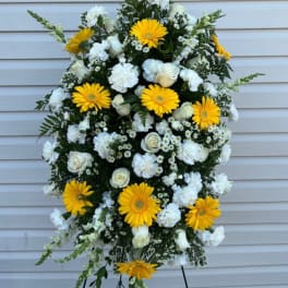 Standing floral spray with yellow gerberas and white flowers