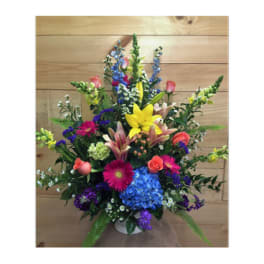 Colorful mixed flower arrangement in a white vase