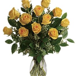 Yellow roses arranged in a clear glass vase