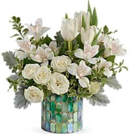 White tulips and roses in a mosaic glass vase