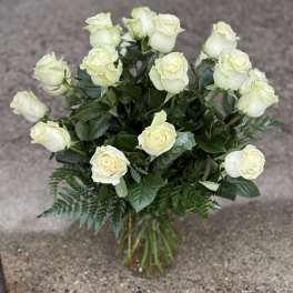 Bouquet of cream white roses in a glass vase