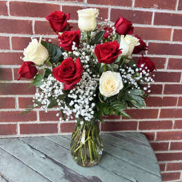 Bouquet of red and white roses in a clear glass vase