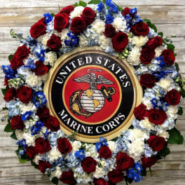 Floral wreath around a United States Marine Corps emblem