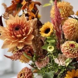 Autumn bouquet with orange dahlias, sunflowers, and mixed blooms