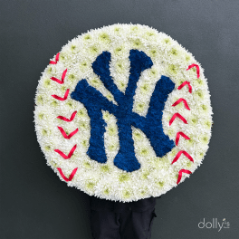 Round floral tribute with a blue Yankees logo and red stitching accents