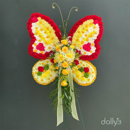 Butterfly-shaped floral standing arrangement with yellow roses and red, white, and yellow flowers