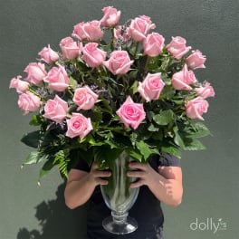 Large bouquet of pink roses in a clear glass vase