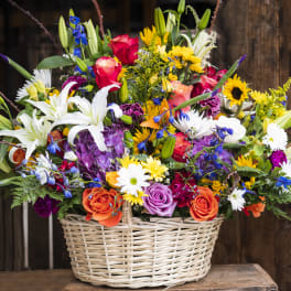 Colorful mixed flower arrangement in a wicker basket