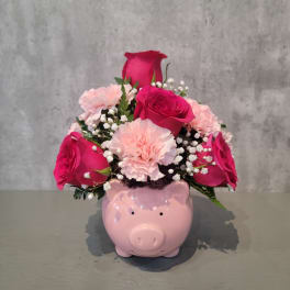 Pink roses and carnations in a pig-shaped vase