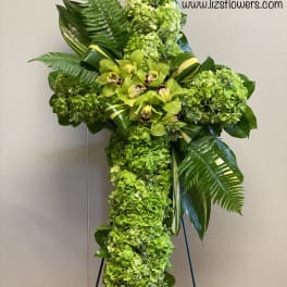 Green floral standing cross with orchids and hydrangeas
