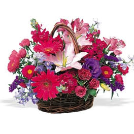 Mixed flower basket with pink lilies, gerbera daisies, and roses