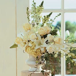 Cream and white floral arrangement in a white vase