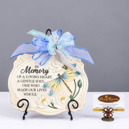 Memorial plaque with blue ribbon and dragonfly decoration on a stand
