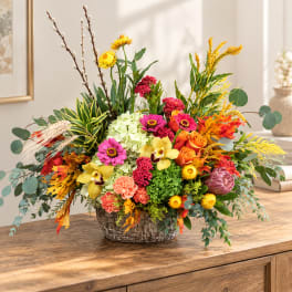 Colorful mixed flower arrangement in a woven basket
