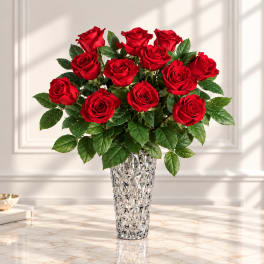 Red roses arranged in a silver textured vase