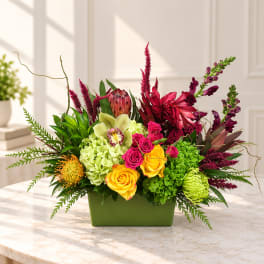 Colorful floral arrangement in a green rectangular container