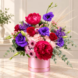 Pink and purple mixed bouquet in a round pink box