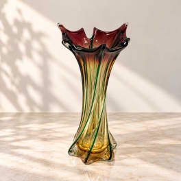 Tall multicolor glass vase with a flared ruffled rim