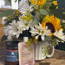 Sunflower and white daisy bouquet in a white mug with tea and honey gifts
