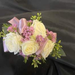 Bouquet of white roses with pink filler flowers and satin ribbon