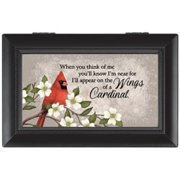 Framed memorial plaque with a cardinal and white flowers