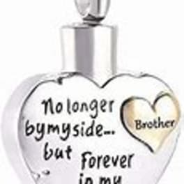 Heart-shaped pendant with engraved memorial text and a smaller heart inset